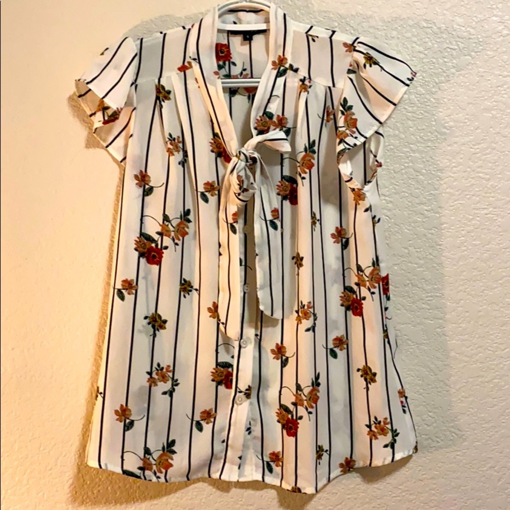 White blouse. Ties in front.